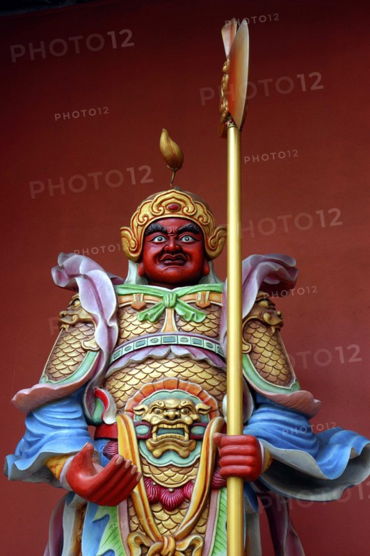 MALAYSIA, Kuala Lumpur, Colourful statue of a figure holding a staff
