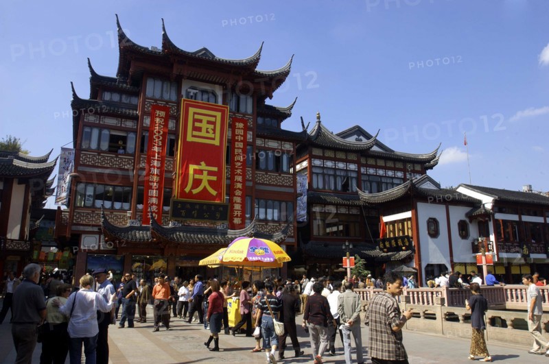 CHINA, Shanghai, Yuyuan Gardens. People gathered below traditional style architecture
