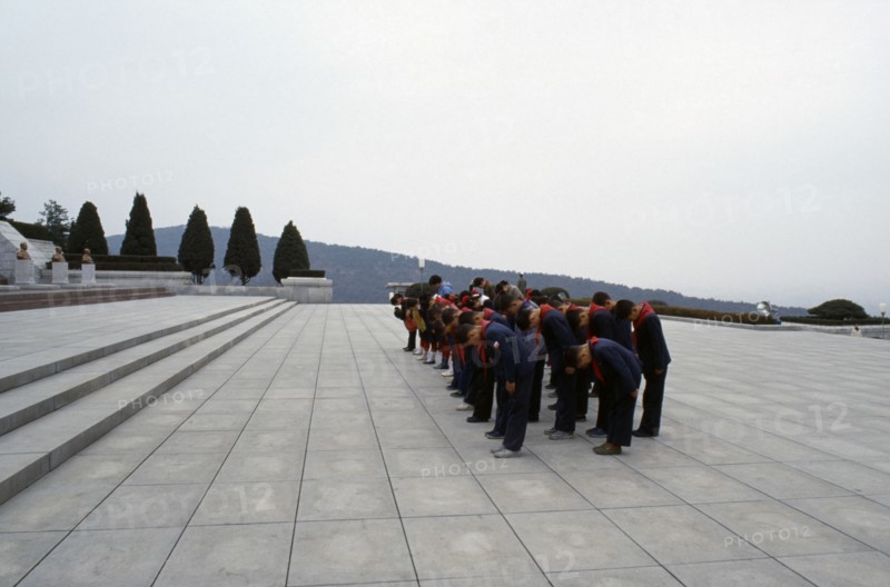 NORTH KOREA, Pyongyang, Group of children paying their respects at the Tomb of the Martyrs outside the city.