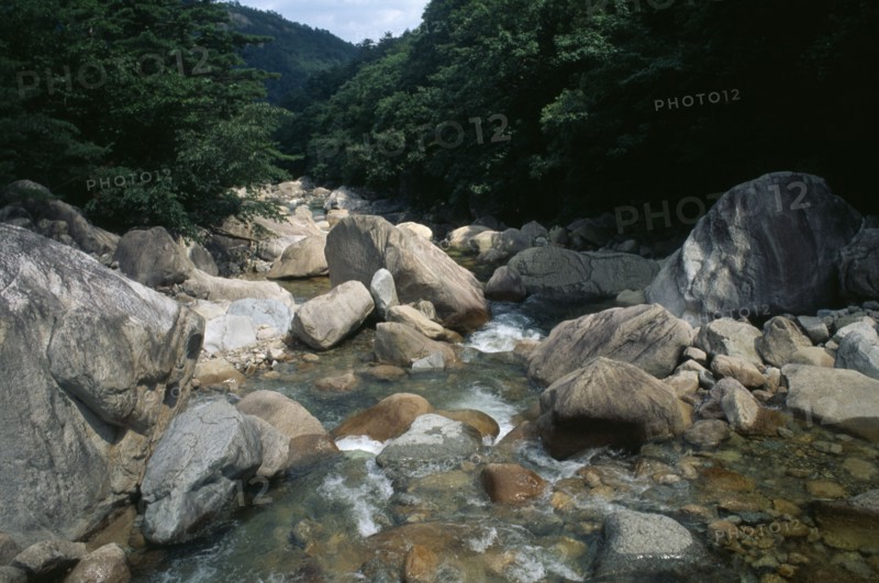 SOUTH KOREA, Kangwon, Soraksan National Park, Sorak Mountains.  Stream flowing over large rocks and boulders.