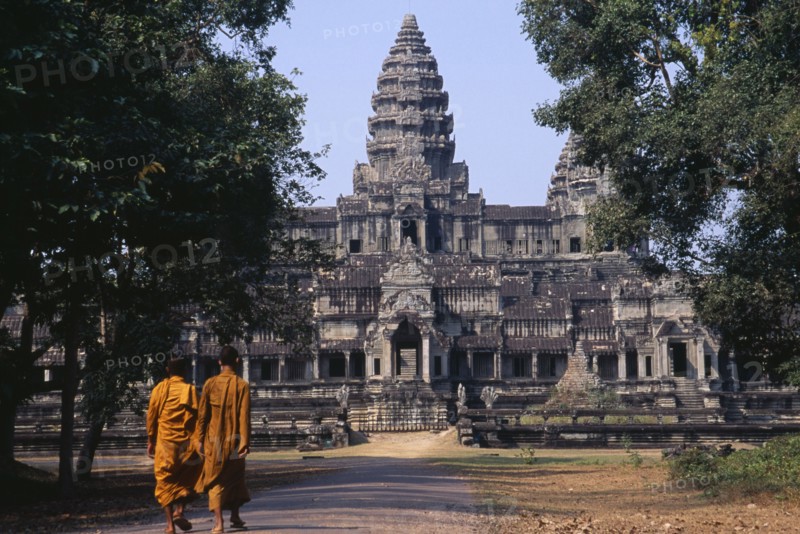 CAMBODIA, Siem Reap, Angkor Wat, Two monks walking on the east road leading to the rear of the main temple building