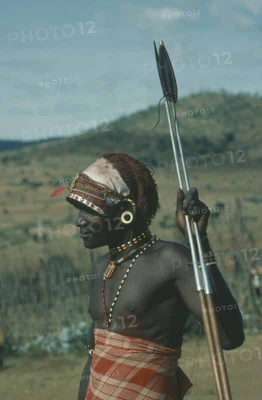 KENYA, Tribal Poeple, Threequarter portrait of Masai Moran warrior holding spear