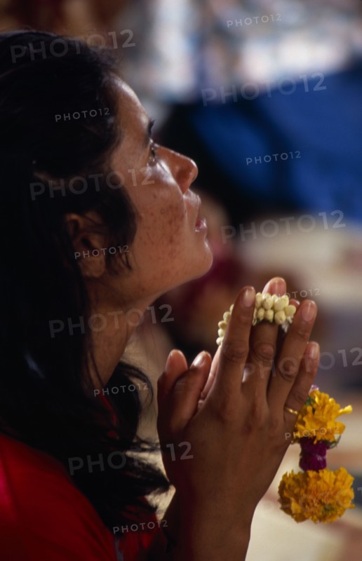 THAILAND, South, Bangkok, Wat Meuang the City pillar the most important animist shrine in Bangkok with female devotee praying
