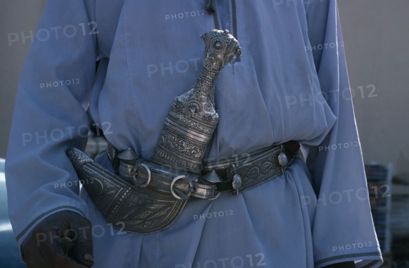 OMAN, General, Detail of traditional silver curved dagger or khanjar worn at the waist by Omani men.
