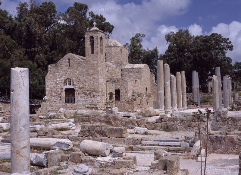CYPRUS, Ayia Kyriaki, Twelth century Byzantine church.  Part restored exterior in area of fallen masonry and ruined remains of standing columns.