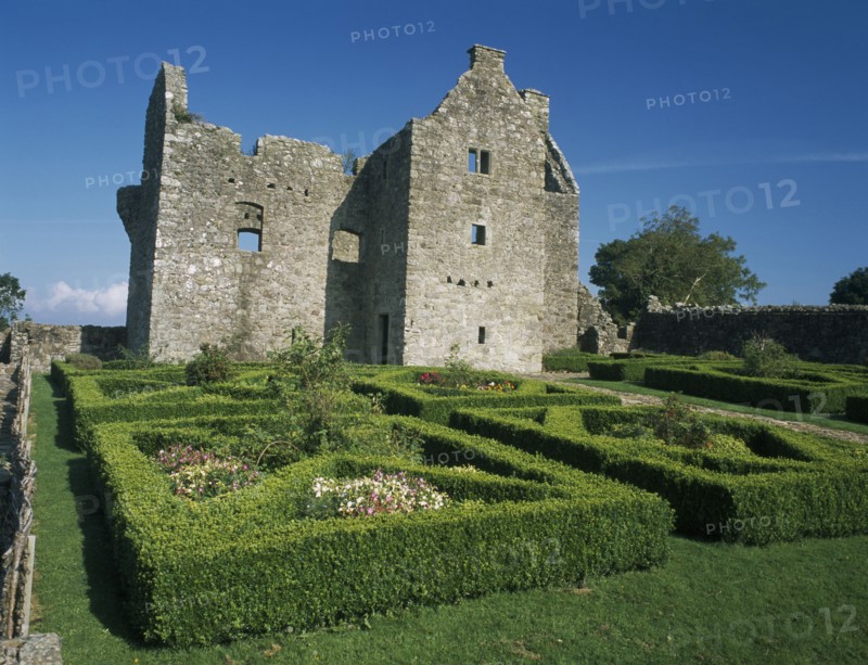 NORTHERN IRELAND, County Fermanagh, Tully, Tully Castle. Ruins of a fortified plantation house dating from 1610 with recently planted early 17th century style formal garden
