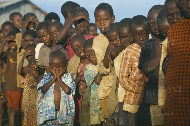 TANZANIA, Henu Oshinga, Hutu refugee children at Henu Oshinga camp waiting for distribution of clothing.