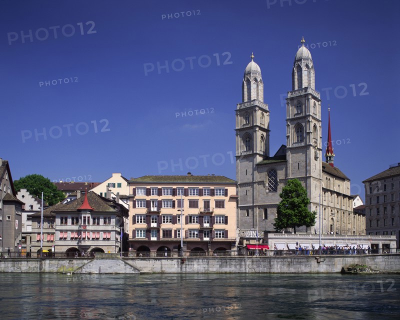 SWITZERLAND, Zurich Canton, Zurich, View across the River Limmat towards Grossmunster twin towered church and waterside buildings.