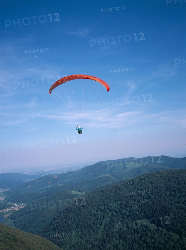 FRANCE, Alsace, Haut Rhin, Paraglider decending from Ballon de l Alsace