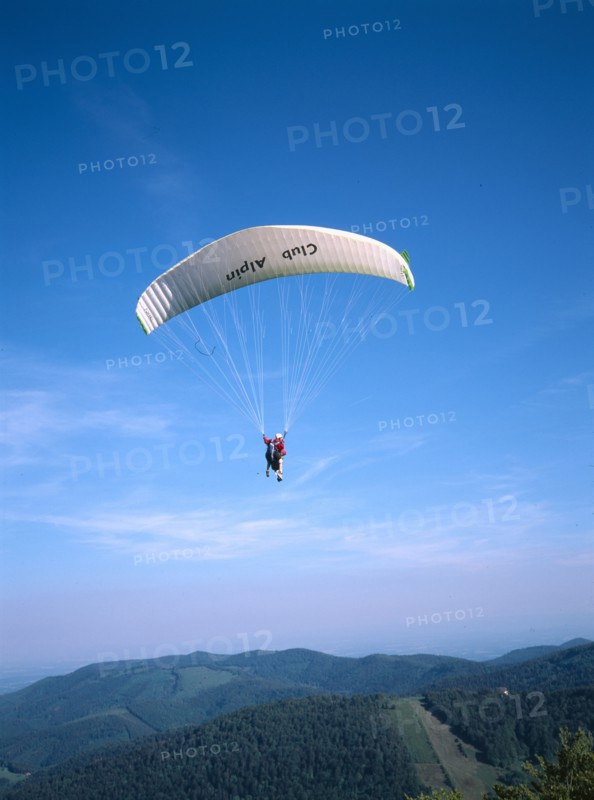 FRANCE, Alsace, Haut Rhin, Paraglider decending from Ballon de l Alsace