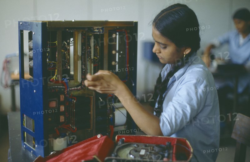 INDIA, Maharashtra, Bombay, Woman working in electronics factory.