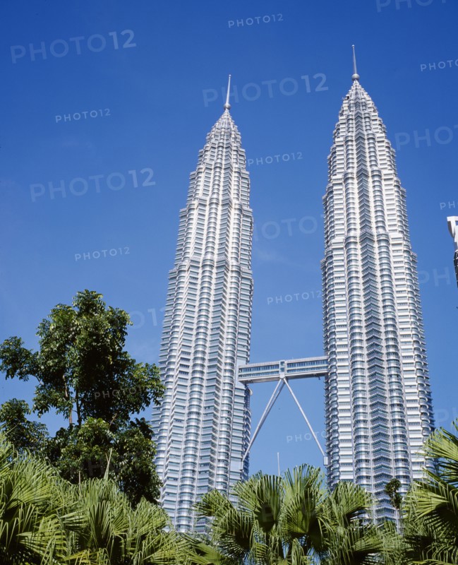 MALAYSIA, Kuala Lumpur, Petronas Twin Towers. Angled view looking up at the multi storey buildings housing corporate headquarters