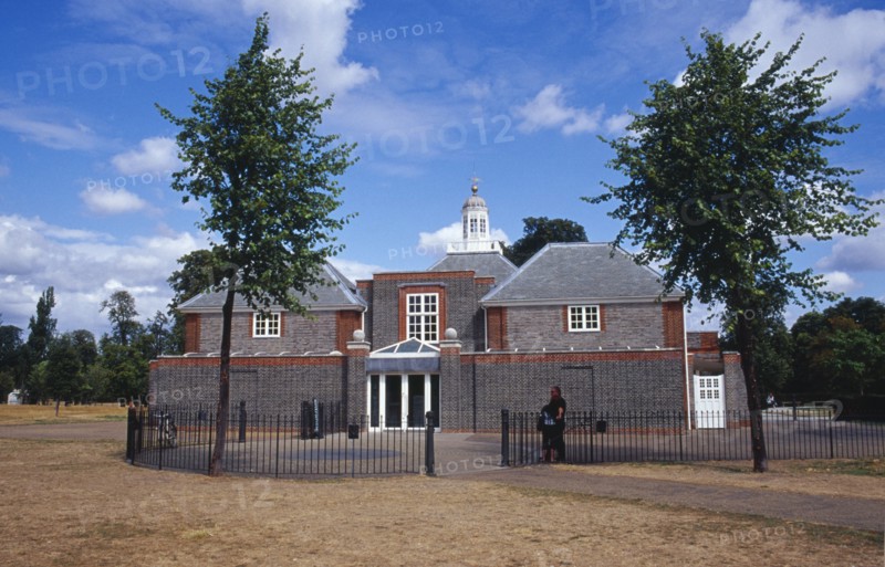 ENGLAND, London, Kensington Gardens.  The Serpentine Gallery exterior with visitors standing beside railings at the entrance.