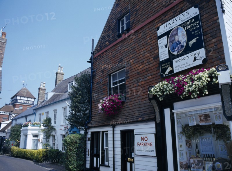 20059216 ENGLAND East Sussex Lewes John Harvey Brewery sign on the side of The Brewery Shop Wall in Cliff High Street with the brewery yard further down the road in the distance.