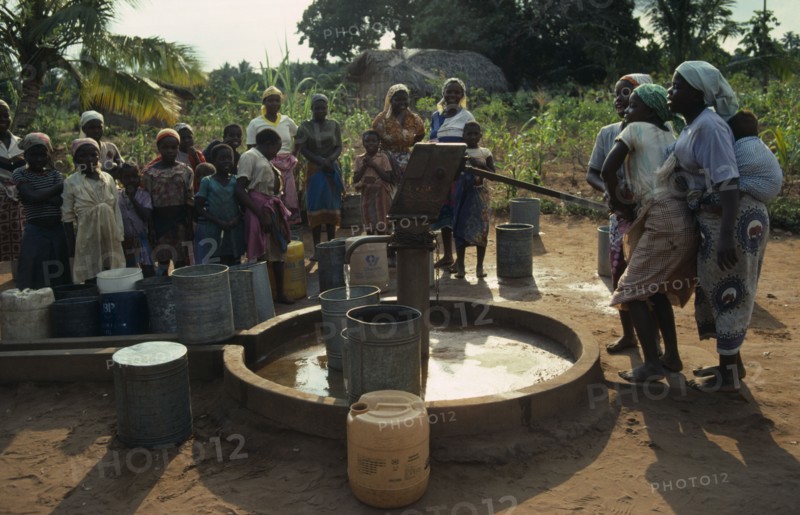 MOZAMBIQUE, Inhambane Province, Water, Village women and children using UNICEF water well.  Water is pumped by hand.