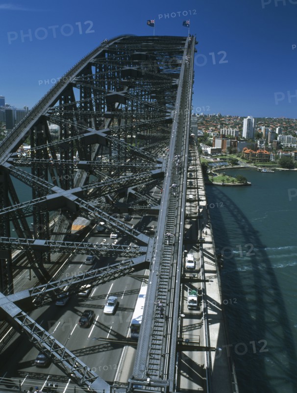 AUSTRALIA, New South Wales, Sydney, Sydney Harbour Bridge seen from Pylon Lookout with people on Bridge Climb below