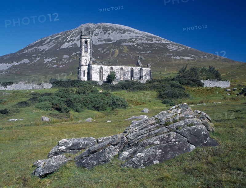 IRELAND, Donegal, Mount Errigal, Ruined church in The Poisened Glen with Errigal peak of the Derryveagh Mountain Range behind