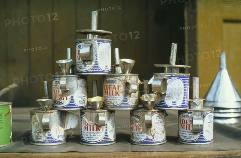 GHANA, Tarkwa, Nestle evaporated milk cans made into oil lamps.