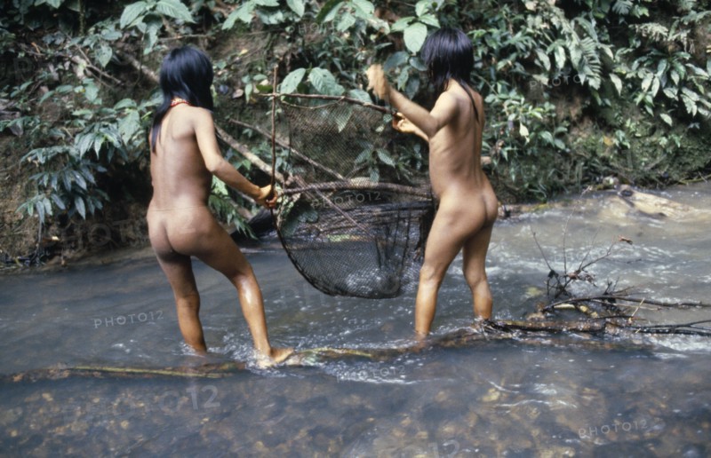 ECUADOR, Amazon, Auca, Two Auca Indian girls fishing with net.