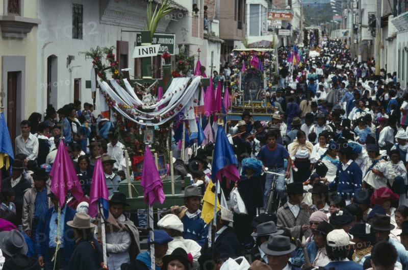 ECUADOR, Imbabura, Cotacachi, Easter procession through narrow street lined with spectators.