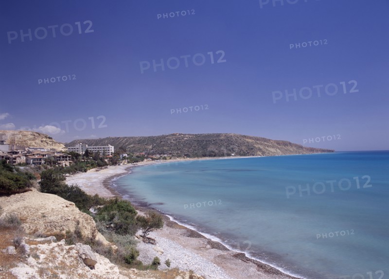 CYPRUS, Pissouri, "Quiet half moon beach and Pissouri Bay with surrounding rocky coastline, hotel and other buildings. "