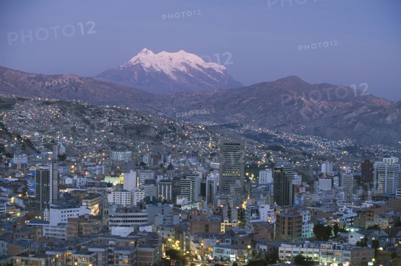BOLIVIA, La Paz, Cityscape and Mount Illimani at dusk.