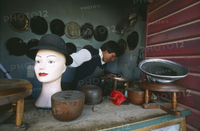 BOLIVIA, La Paz, El Alto, Hat maker in La Ceja making traditional brown and grey bowler hats known locally as a bombin.