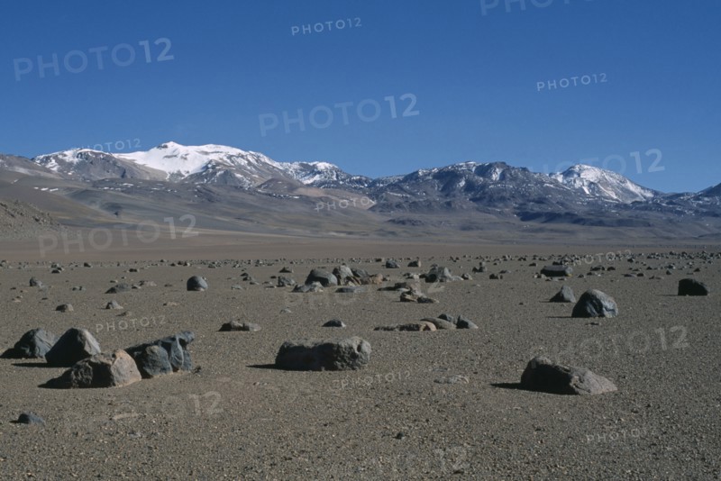BOLIVIA, Altiplano, Potosi, Salar de Uyuni.  Desert landscape scattered with rocks near Laguna Verde.