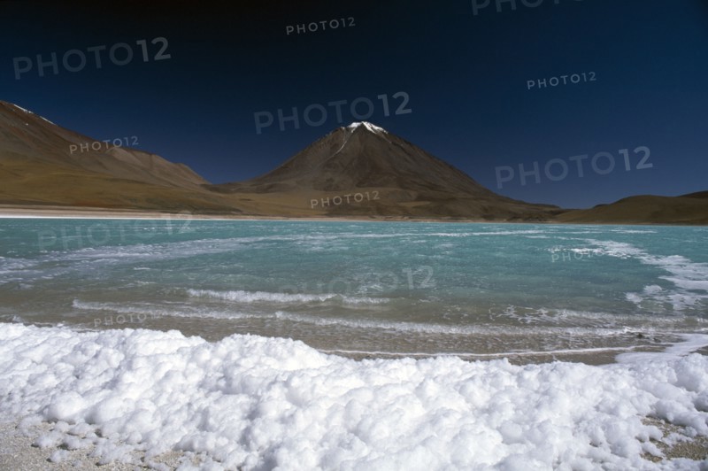 BOLIVIA, Altiplano, Potosi, "Salar de Uyuni, Laguna Verde.  Salt crusted shore and jade coloured water."