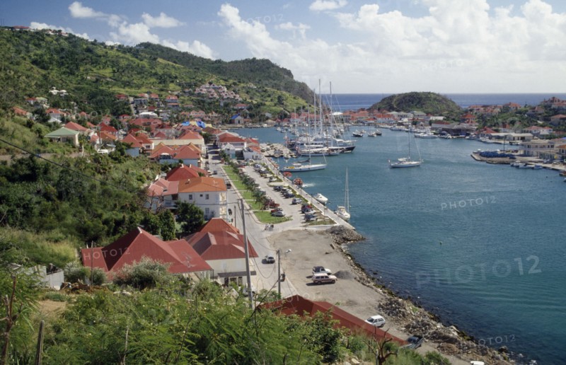 WEST INDIES, St Barthelemy, Gustavia, View over the port with yachts on water and houses built along bottom of hillside