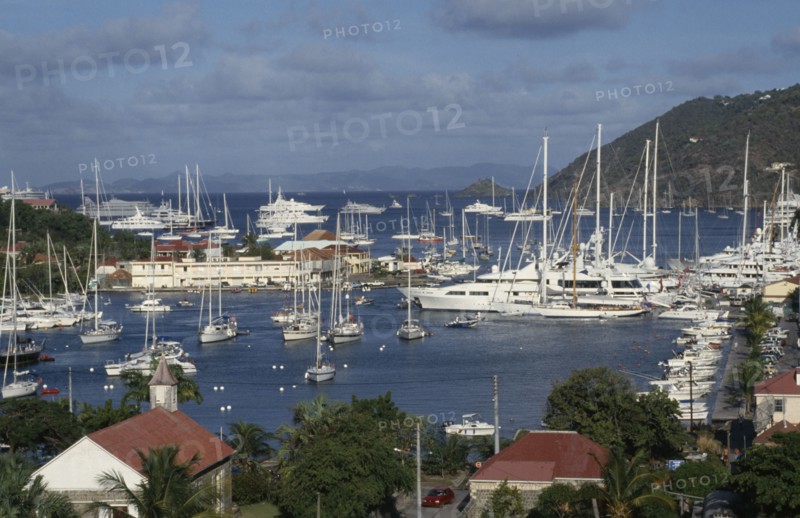 WEST INDIES, St Barthelemy, Gustavia, View over the port with yachts moored on water.