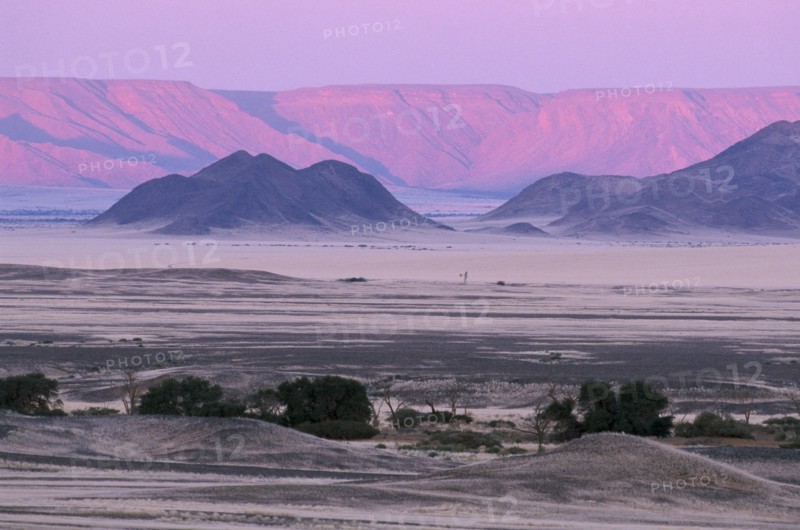 NAMIBIA, Namib Desert, Desert mountains and plains with pink and purple sky overhead