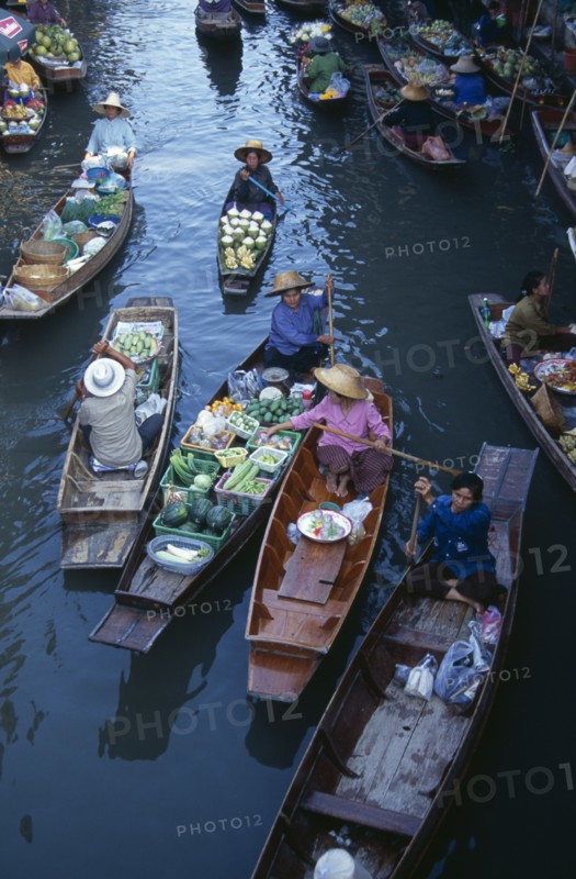 THAILAND, South, Bangkok, Damnoen Saduak Floating Market fruit vendors in their canoes on the main canal