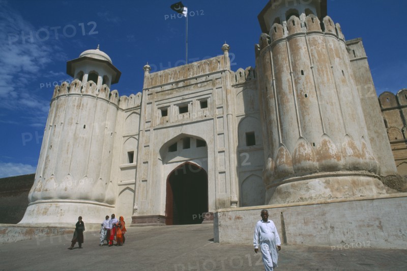 PAKISTAN, Punjab, Lahore, Lahore Fort.  Group of women on road walking away from Alamgiri Gate with man in foreground.
