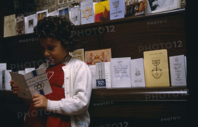ENGLAND, Religion, Judaism, Little girl looking at greetings cards for Jewish New Year.