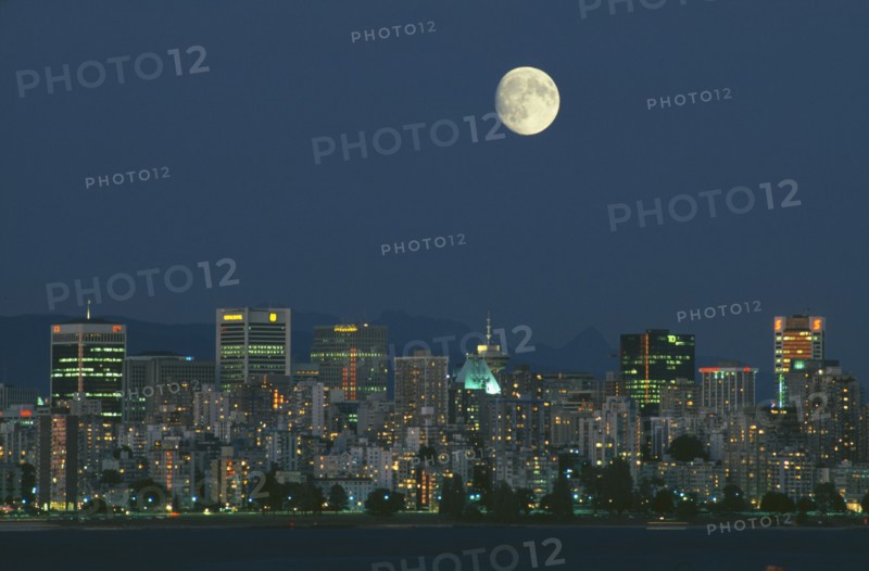 CANADA, British Columbia, Vancouver, Full moon over downtown Vancouver at dusk.