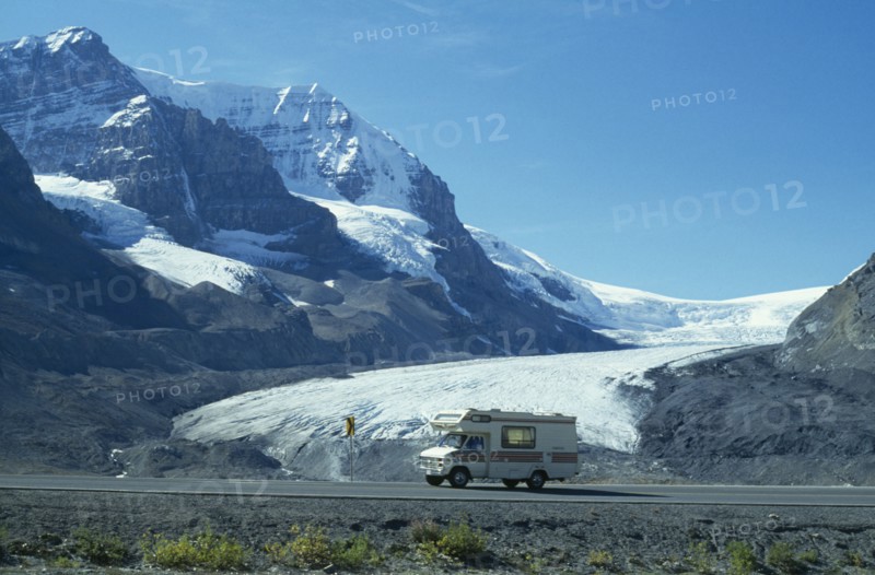 CANADA, British Columbia, Jasper National Park, Canadian Rocky Mountains.  A holiday van on the Icefield Parkway passing the Athabasca Glacier.