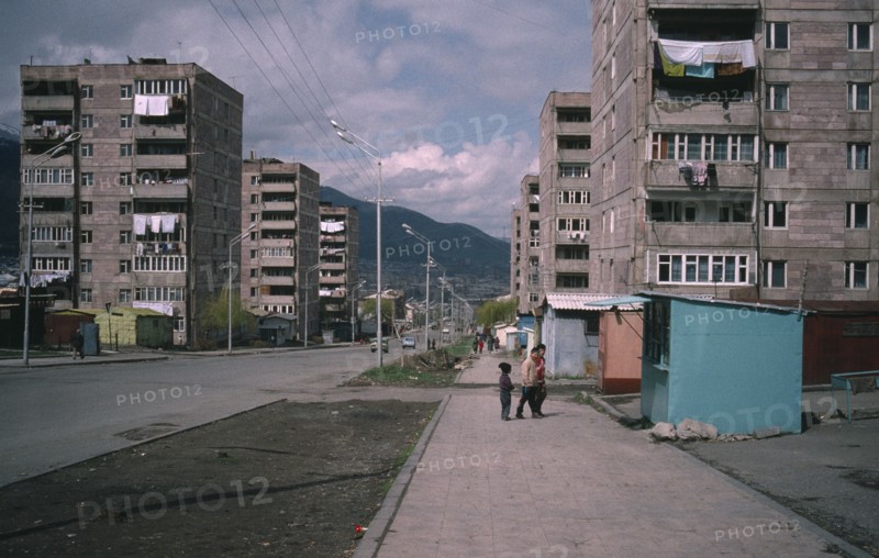 ARMENIA, Vanadzor, Children on street beside residential flats.