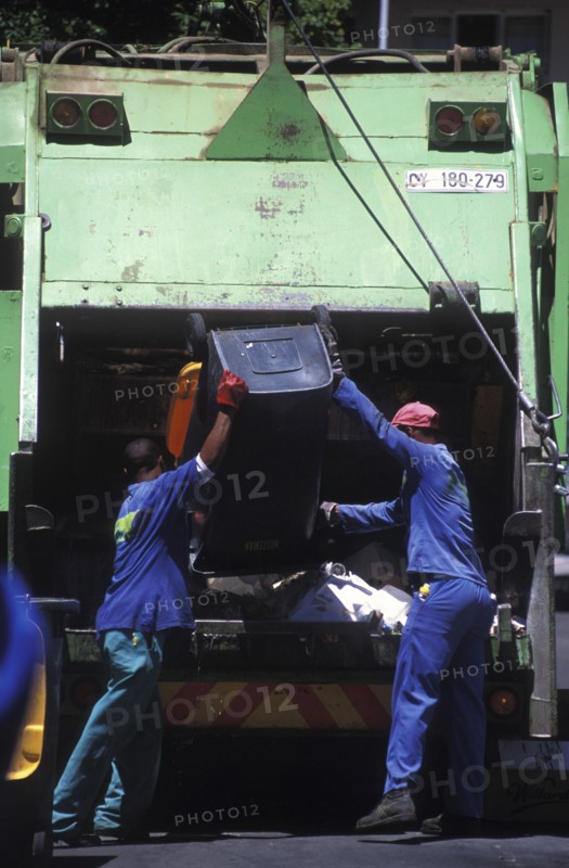 SOUTH AFRICA, Western Cape, Paarl, Municipal refuse collectors emptying waste bins into the truck