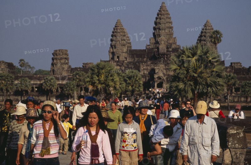 CAMBODIA, Siem Reap Province, Angkor Wat, Tourists on stone causeway leading to temple complex.  Many Cambodians visiting during Chinese New Year.