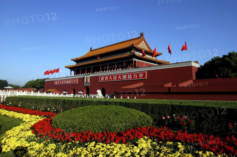 CHINA, Beijing, Tiananmen Square, Tiananmen Monument aka Gate of Heavenly Peace with portrait of Mao on the front and flower beds in the foreground