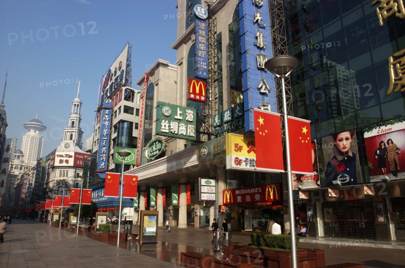 CHINA, Shanghai, Nanjing Road walking street. Commercial shopping street with building facades covered with a mass of advertising signs
