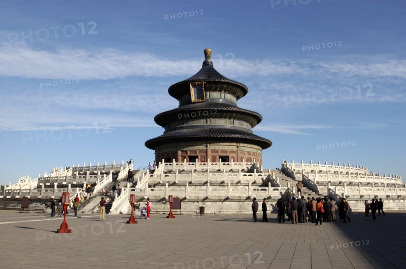 CHINA, Beijing, Tiantan Park, aka The Temple of Heaven. View of the Hall of Prayer for Good Harvests with people gathered at the base of the steps