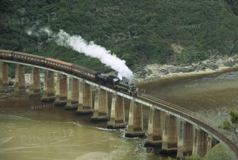 SOUTH AFRICA, Western Cape, Wilderness National Park, Tootsie steam train on bridge at Dolphin Point travelling between George and Knysna