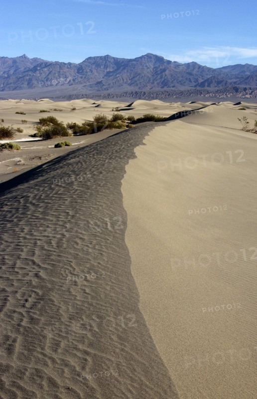 USA, California, Death Valley, View along the ridge of a sand dune in the desert landscape with a rocky horizon in the distance