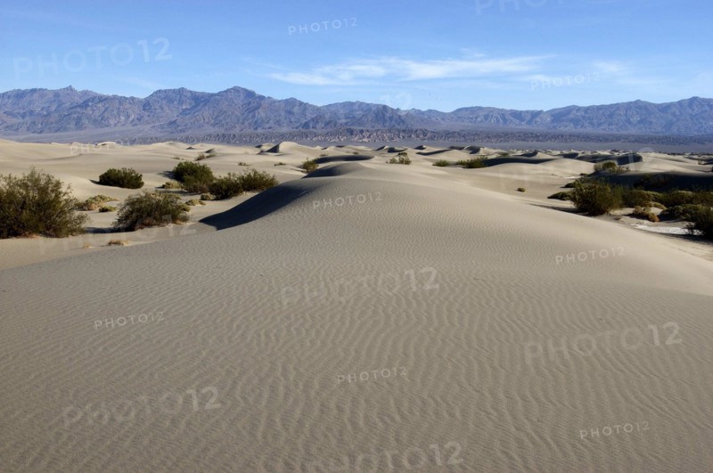 USA, California, Death Valley, View over sand dunes in the desert landscape toward rocky horizon