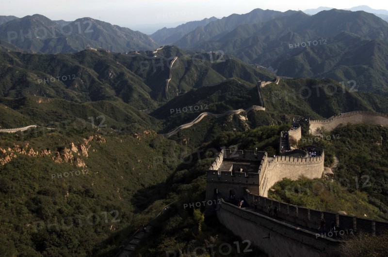 CHINA, Great Wall, View over a section of the wall which leads through the green hilly landscape