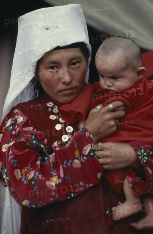 AFGHANISTAN, People, Portrait of Kirghiz woman holding baby.