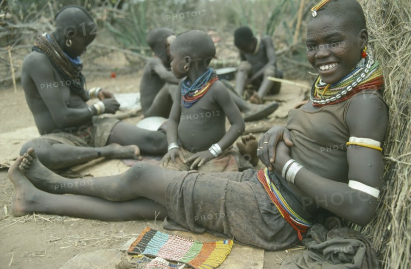 UGANDA, Karamoja, Karamojong girl from the Mathenico clan wearing traditional bead jewellery and with beadwork to be worn by unmarried girls.