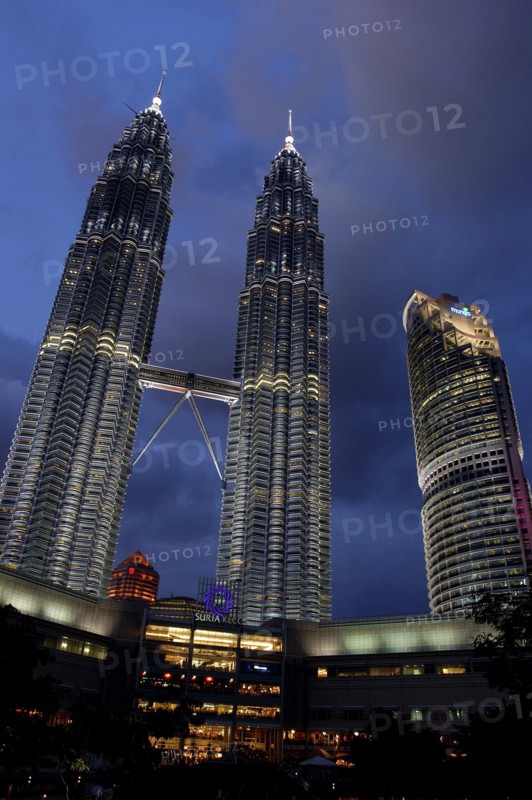 MALAYSIA, Kuala Lumpur, Angled view looking up at the Petronas Twin Towers illuminated at night
